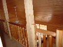 Upstairs hall railing looking down into the livingroom.