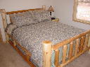 Bedroom featuring log furniture at Wilderness Pines.