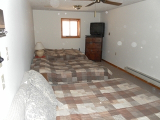 Lower level bedroom with 3 double beds.